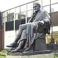 The statue of John Dalton by William Theed outside the university's building in Chester Street